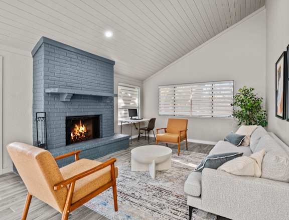 a living room with a fireplace and a couch  at The Frederick, San Antonio
