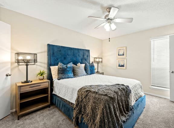 a bedroom with a bed and a ceiling fan at Keller Oaks, Carrollton, TX 75006