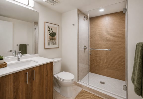 A bathroom with a toilet, sink, and shower.