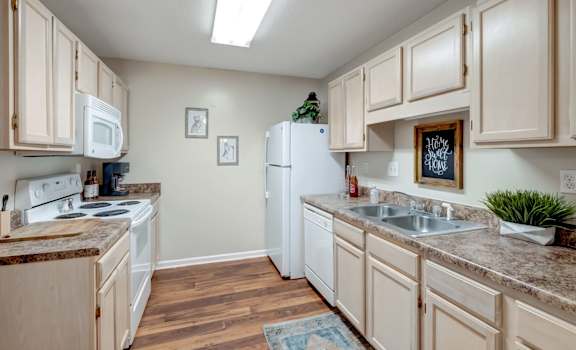 A kitchen with wooden cabinets and a white refrigerator.
