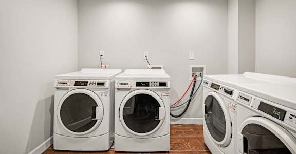 a washer and dryer in a laundry room with two washes and two