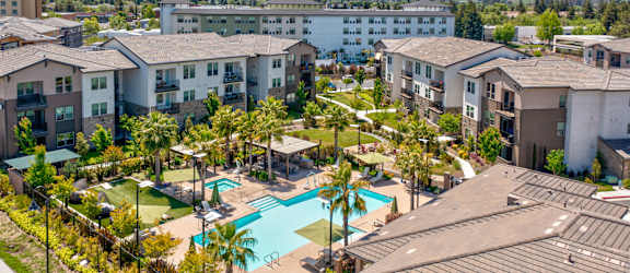 an aerial view of the resort style pool at the bradley braddock road station apartments