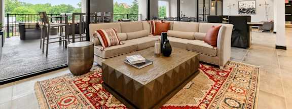 A living room with a large sofa and a coffee table.