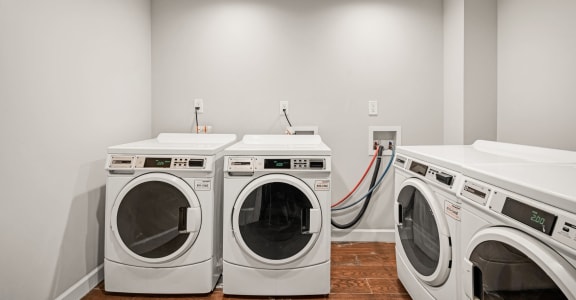a washer and dryer in a laundry room with two washes and two