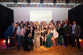 a group of people posing for a photo at a party