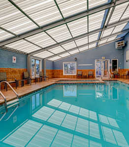 A large indoor swimming pool with a tiled floor.