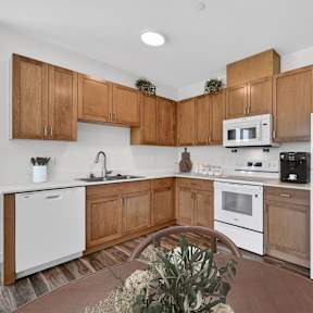 A kitchen with wooden cabinets and white appliances.