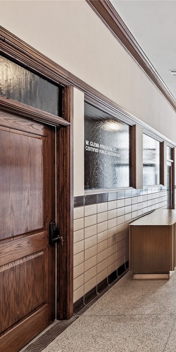 A hallway with a bench and a sign that says "Keller Realty Inc."