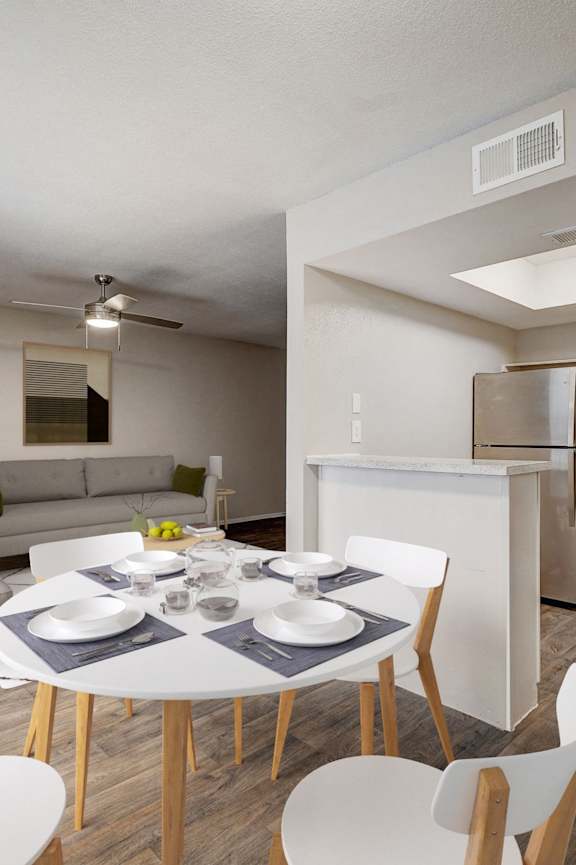 a living room and dining room with a white table and chairs