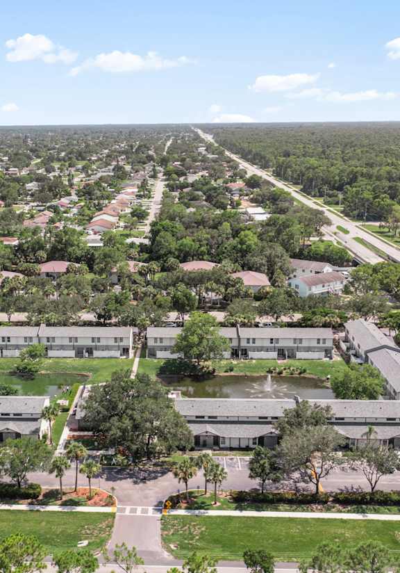 A bird's eye view of a residential area with a road running through it.