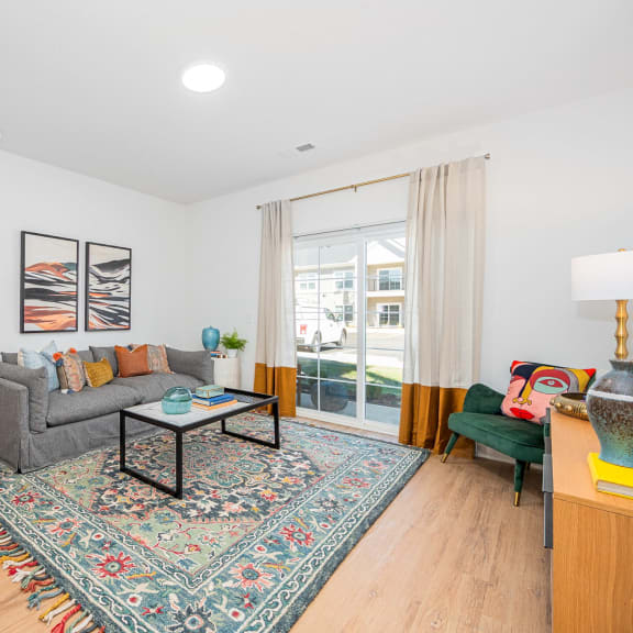 a living room with a couch and a table     and a door