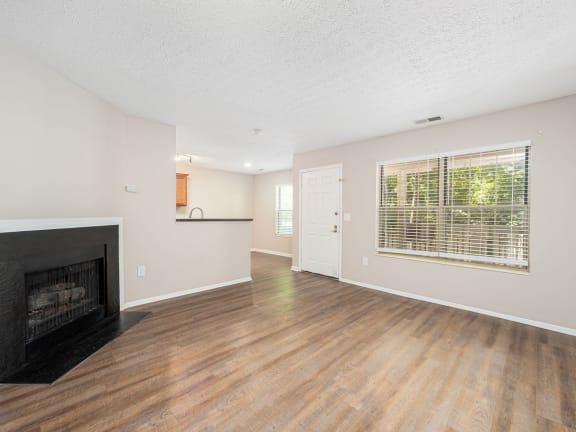 a living room with a fireplace and a window