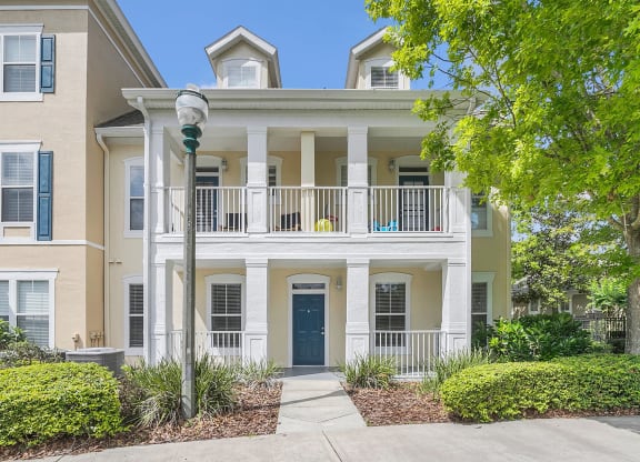 an apartment building with a blue door and a balcony at Northlake Park, Orlando