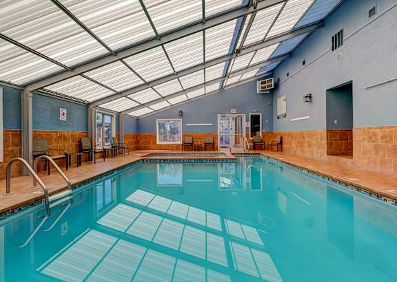 A large indoor swimming pool with a tiled floor.