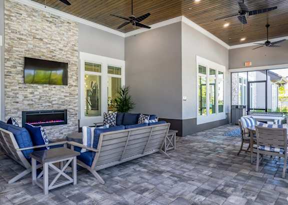 A patio with a fireplace and seating area.