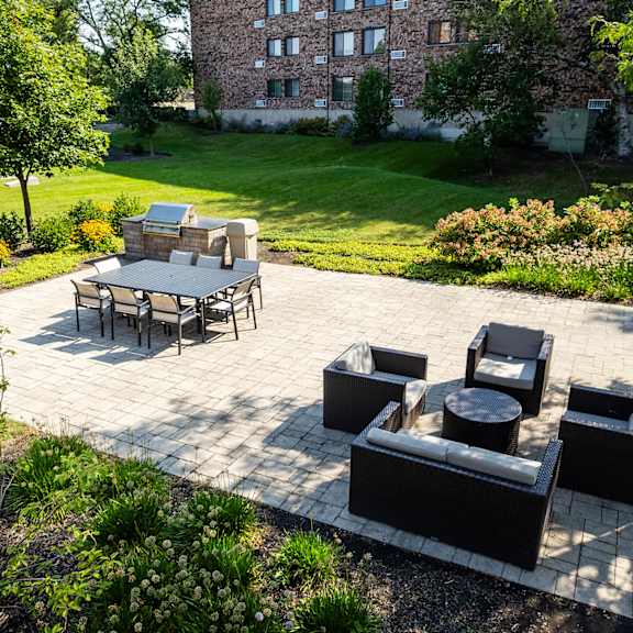 Outdoor lounge area featuring modern patio furniture including dining tables and conversation seating on patio