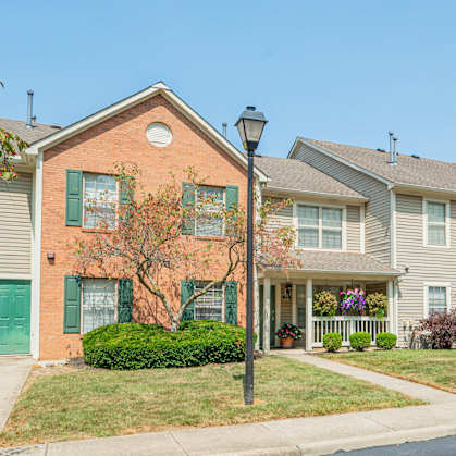 a row of houses with a sidewalk in front of them
