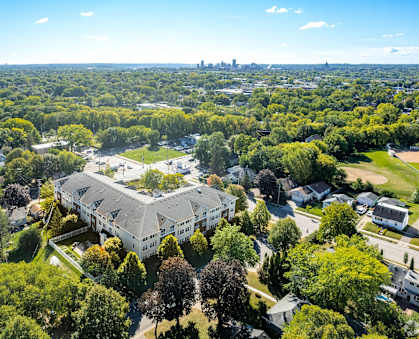A bird's eye view of a residential area with a large building in the center.