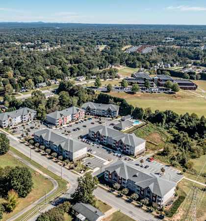 A bird's eye view of a residential area with houses and a large building.