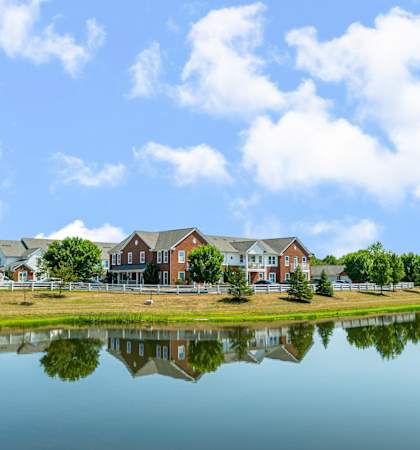 the view of a building reflected in a pond