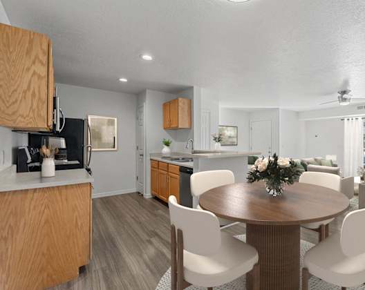A modern kitchen with a dining table set for four. at Eagles Landing, Ammon, ID