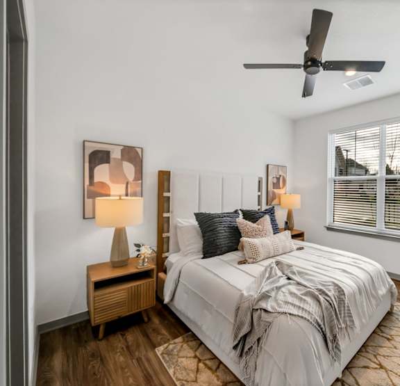 A bedroom with a bed, nightstand at The Levi Luxury Apartments, McDonough, Georgia