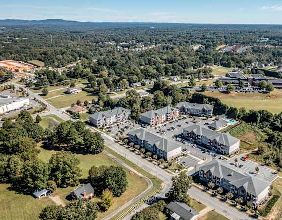 A bird's eye view of a residential area with houses and a large building.