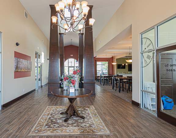 a large lobby with a table and a chandelier