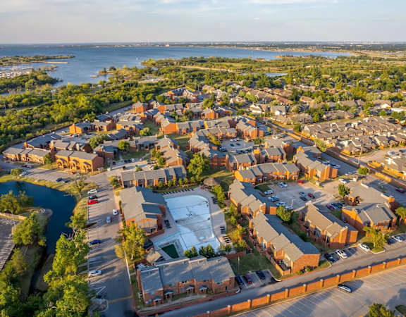 A bird's eye view of a residential area with houses and a river.