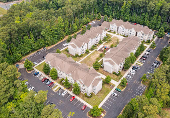 arial view of a subdivision of houses with trees in the background