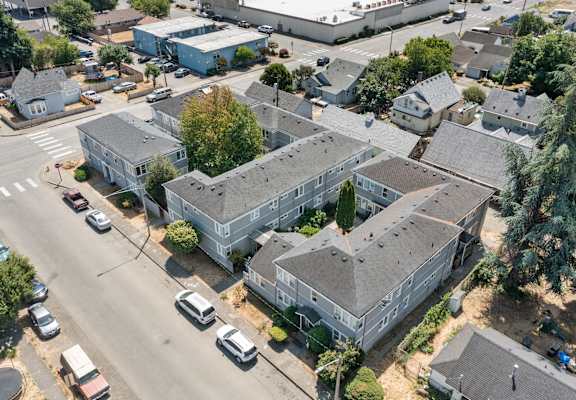 arial view of a large gray building with a gray roof