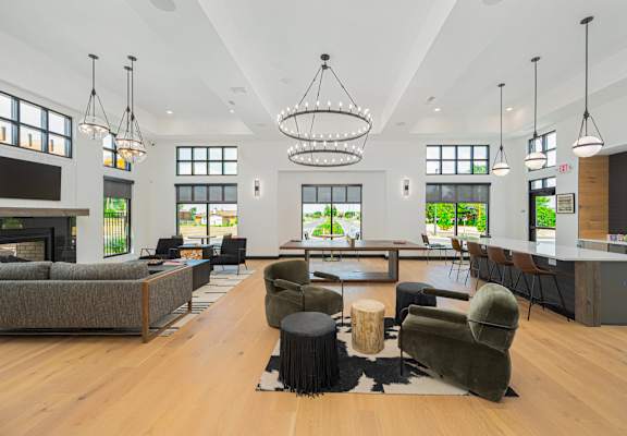 a large living room with couches and chairs and a fireplace