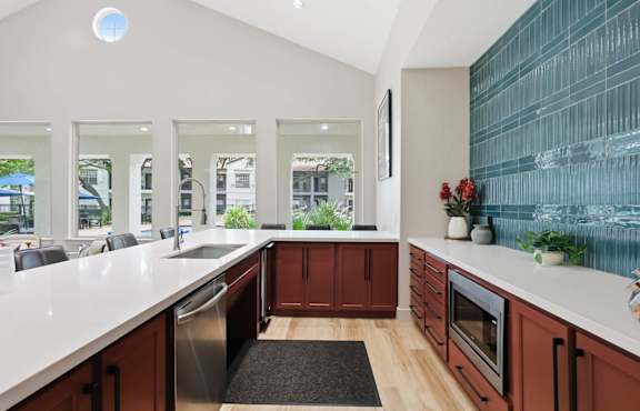 A modern kitchen with wooden cabinets and a large island.
