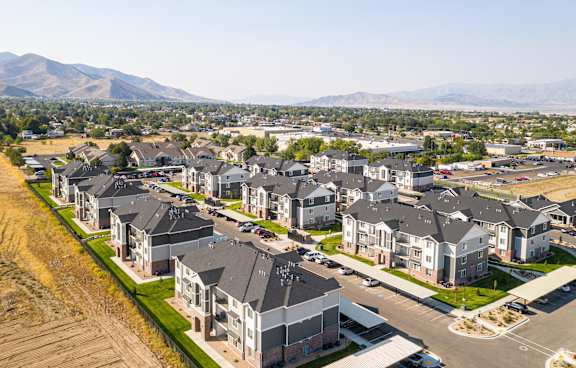 A row of houses with a mountain in the background.