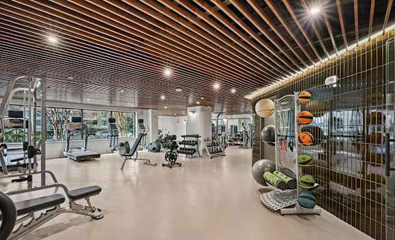 A gym with a variety of equipment including weights and machines.