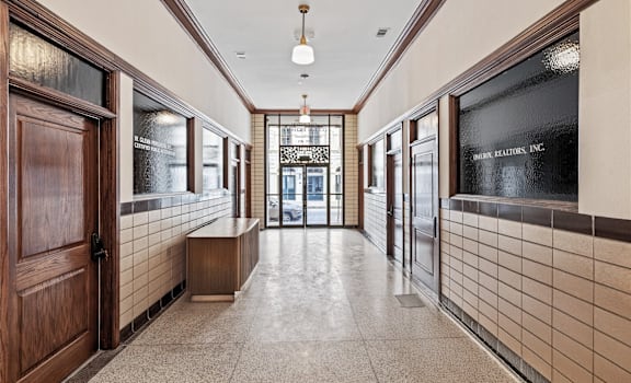 A hallway with a bench and a sign that says "Keller Realty Inc."
