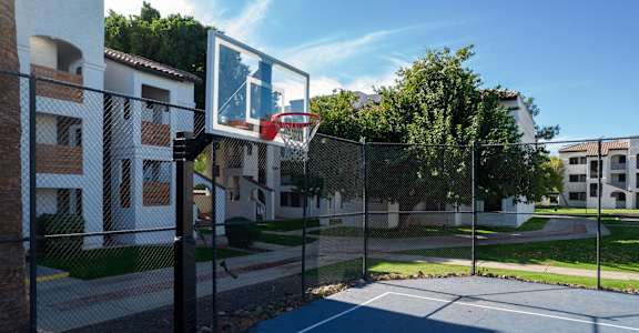 a basketball hoop on a court in front of apartments at Tides on Southern, Arizona