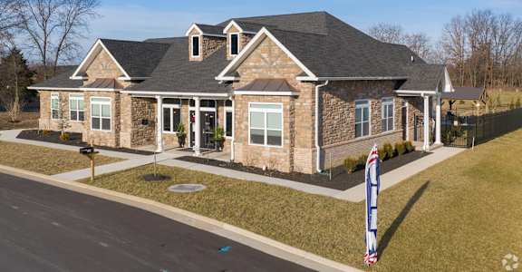 A house with a flag on the lawn.