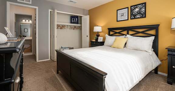 a bedroom with a large bed and a closet