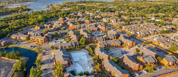 A bird's eye view of a residential area with houses and a river.