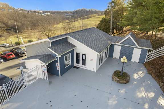 a house with a gray roof and a blue and white house