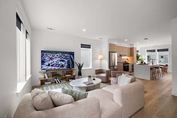 A modern living room with a large couch and a television.