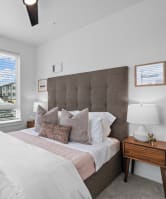 a bedroom with a large bed and a window