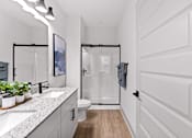 Thumbnail 19 of 19 - A white bathroom with a walk-in shower and a toilet.