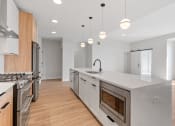 Thumbnail 6 of 28 - Expansive Kitchen Island with Overhead Lighting