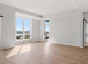 Thumbnail 8 of 28 - Spacious Living Area with Hardwood-Style Flooring