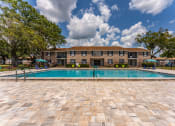 Thumbnail 17 of 18 - a swimming pool with a building in the background at Jacksonville Heights Apartments