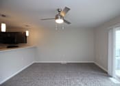 Thumbnail 2 of 14 - A room with a ceiling fan and carpeted floor.