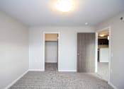 Thumbnail 3 of 14 - A room with a grey carpet and a white door.
