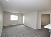 Thumbnail 8 of 14 - A spacious room with a ceiling fan and a window.